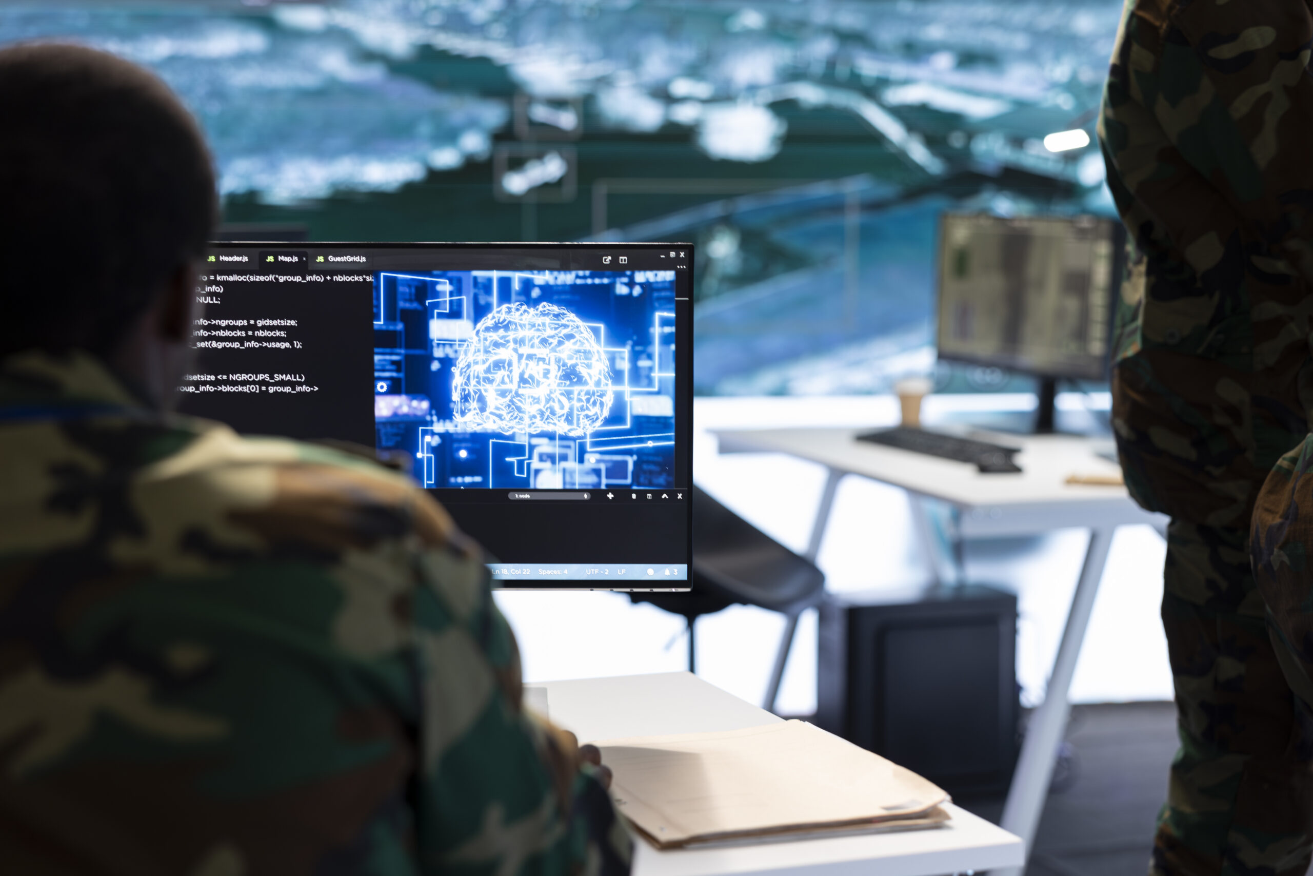 Military operators reviewing AI-enabled battlefield intelligence on a secure system.